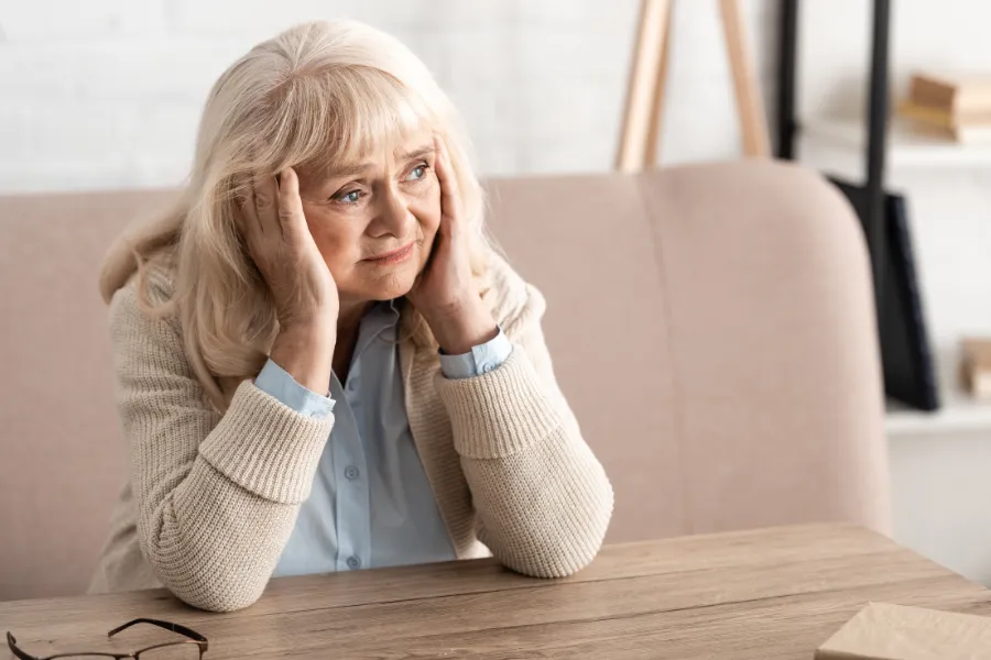 Woman thinking in a booth table